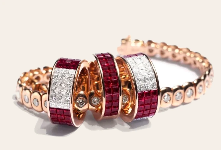 Bespoke ruby and diamond bracelet with matching invisible-set ruby and diamond rings in rose gold