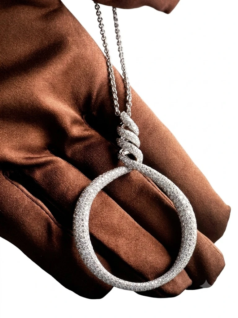 White gold pavé diamond circle pendant on chain, held on brown velvet glove, Amanda Jewellery