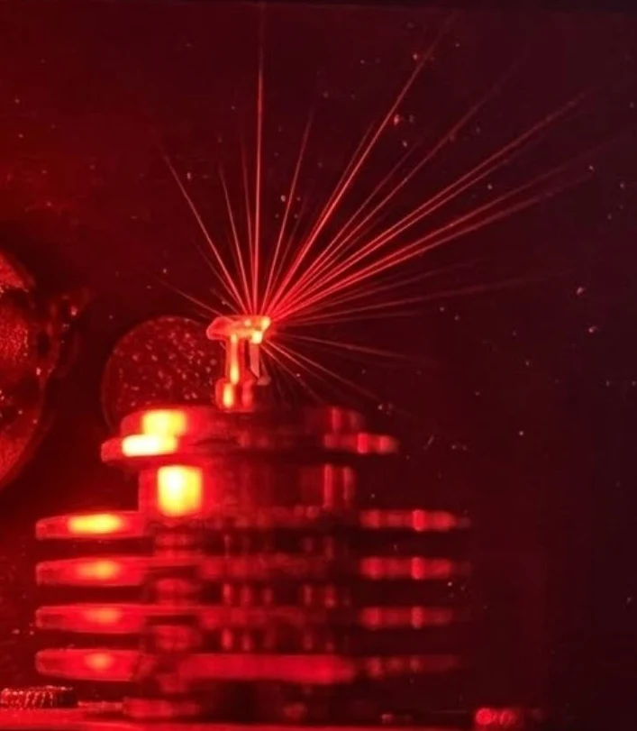 Laser cutting system precisely shaping a gemstone at Amanda Jewellery's Bangkok lapidary