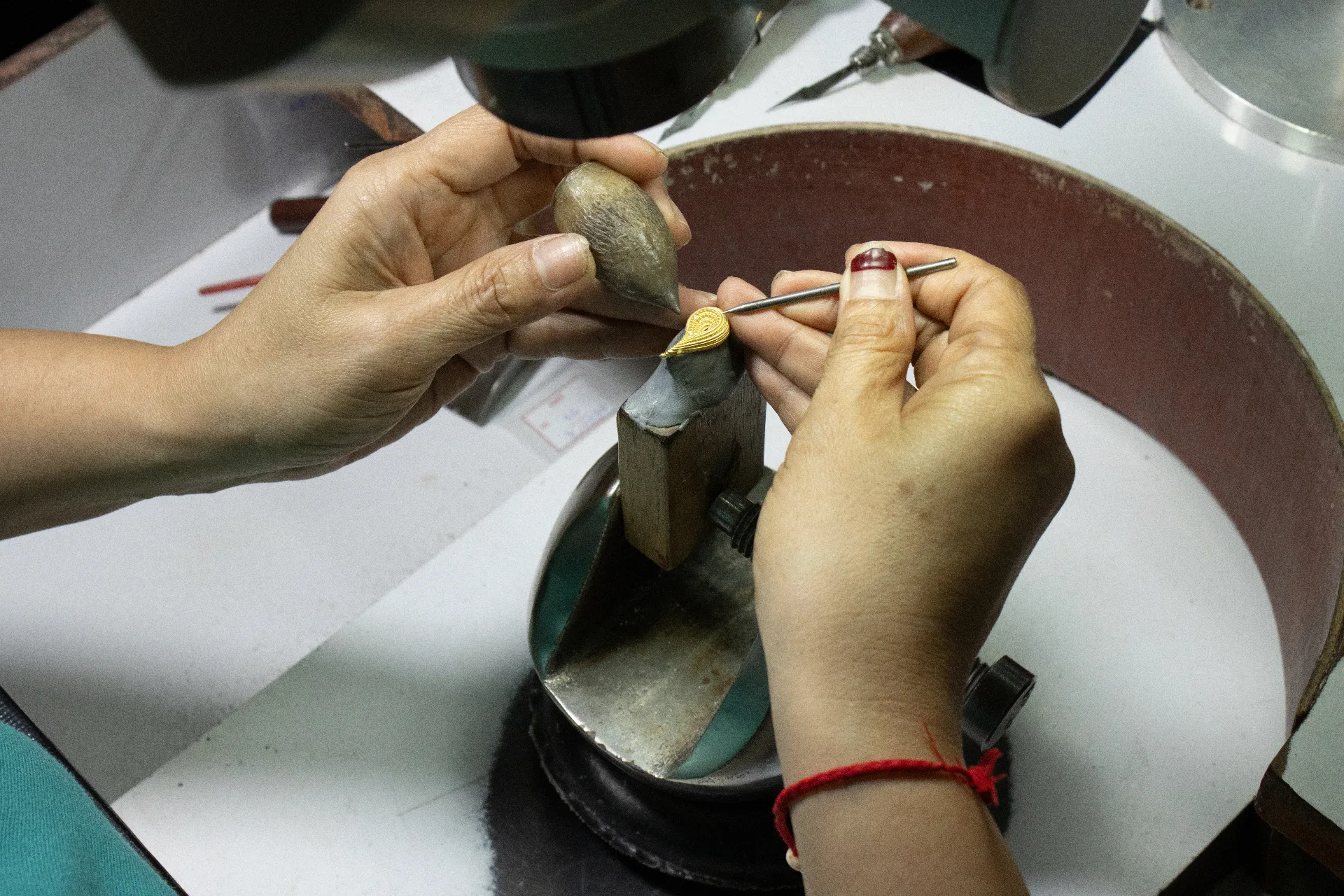 Overhead view of a jewellery design studio with CAD drawings and wax models